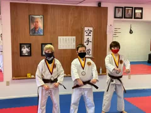 a group of people in karate uniforms