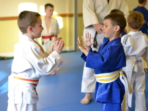 a group of children in karate uniforms