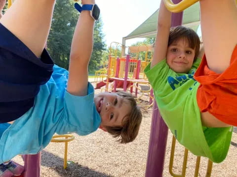 a boy and girl playing on a playground