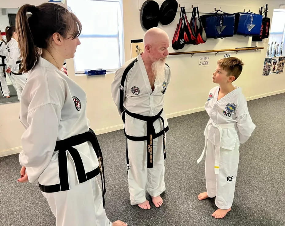 a man and a woman in karate uniforms