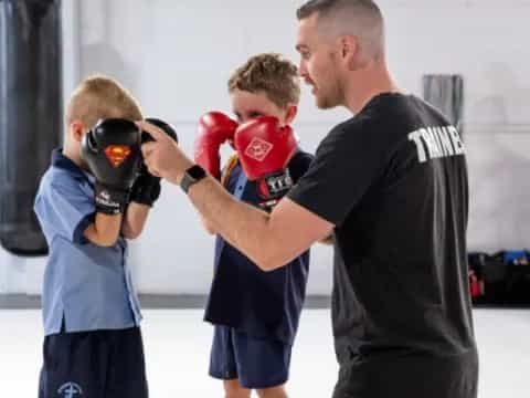 a man with boxing gloves and a boy with a boxing glove