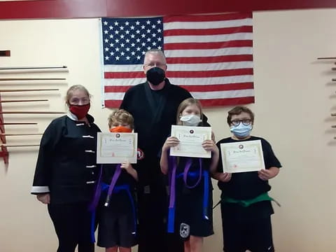 a group of children holding certificates