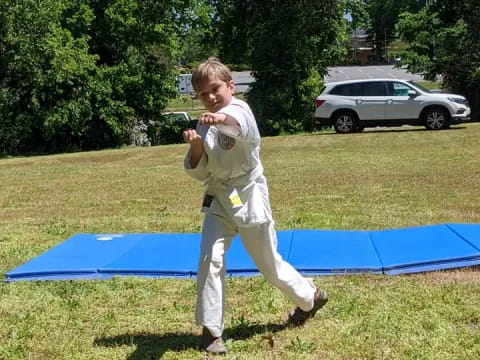 a boy in a karate uniform