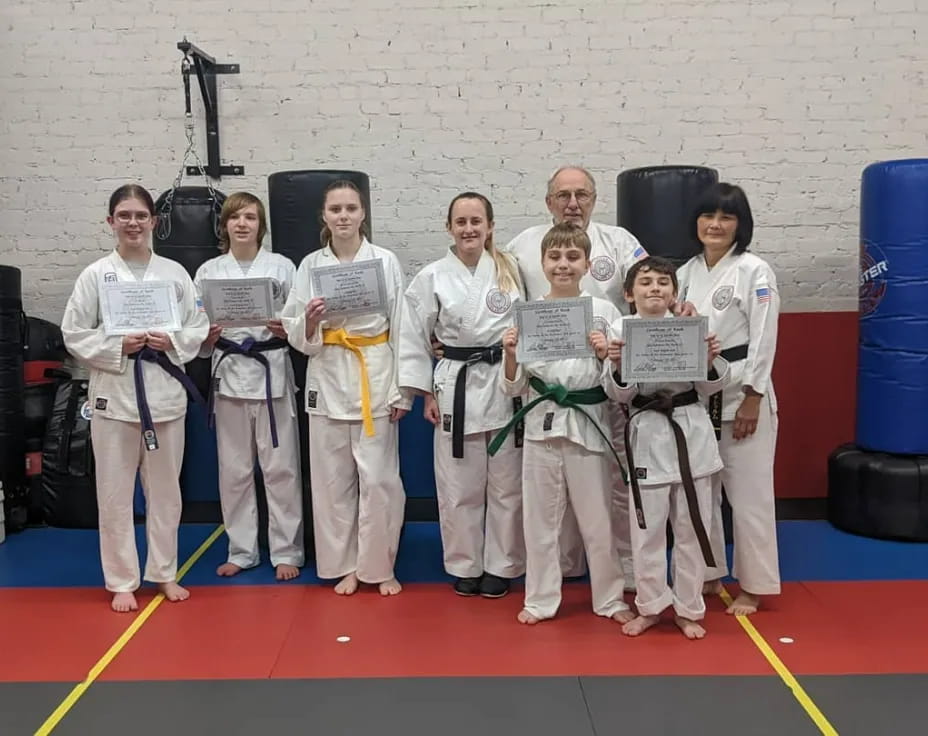 a group of people in karate uniforms