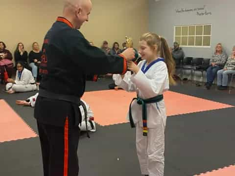 a man and a woman in a karate uniform