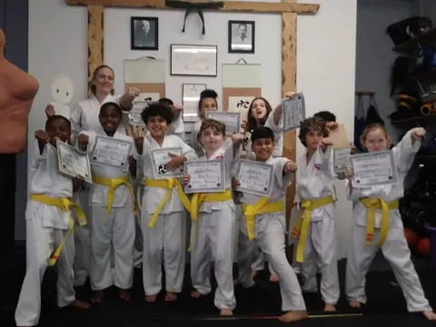 a group of children in karate uniforms