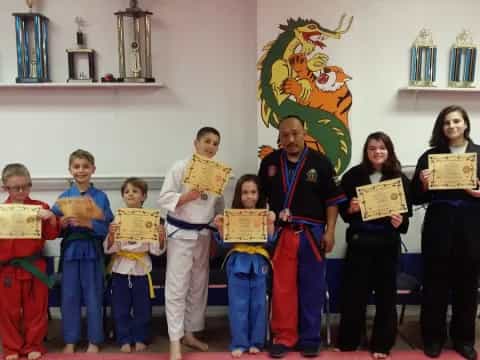 a group of children holding certificates