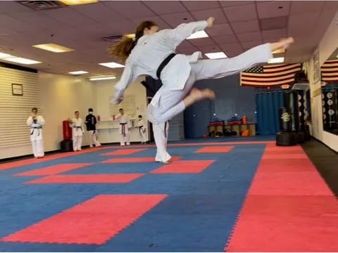 a man doing a handstand on a mat in a gym