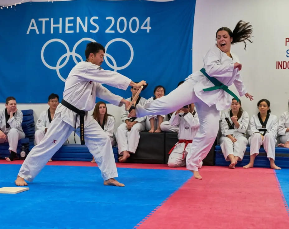 a man and woman practicing martial arts