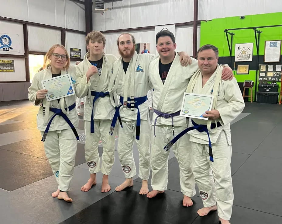 a group of people in white lab coats posing for a photo