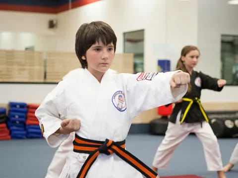 a young boy in a karate uniform