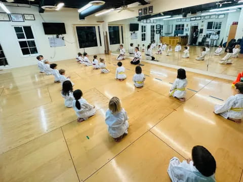 a group of people sitting on the floor in a room