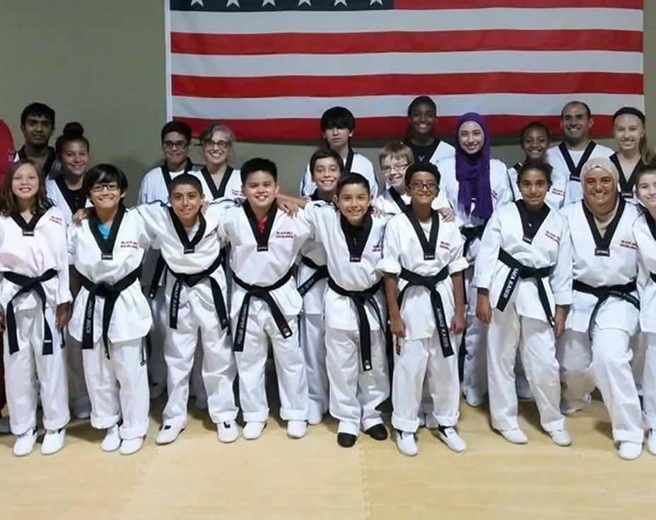 a group of people in karate uniforms