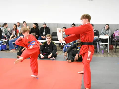 two people in red karate uniforms