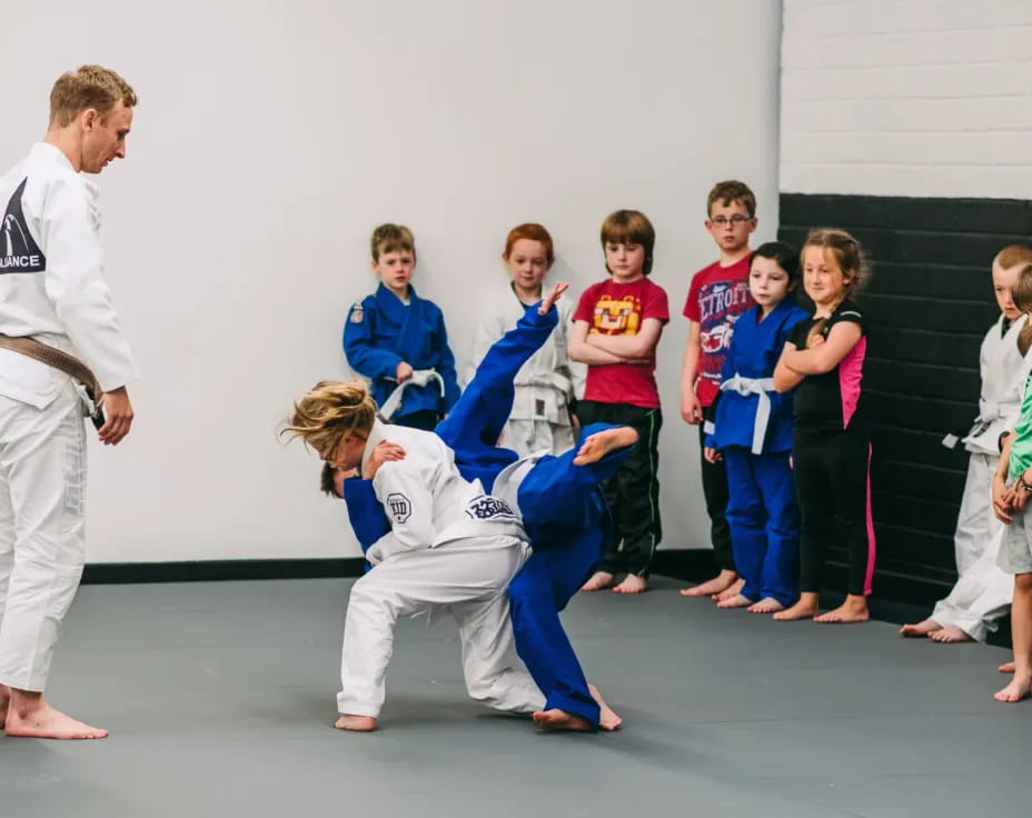 a group of children in karate uniforms