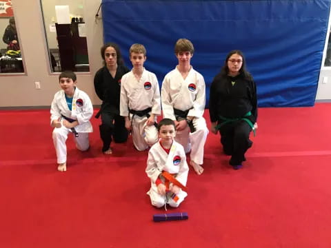 a group of people in karate uniforms