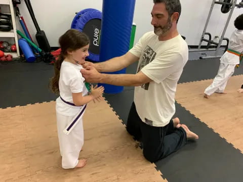 a man and a girl in a gym