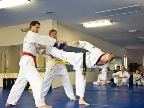 a group of people in karate uniforms