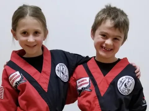 a couple of boys wearing football uniforms