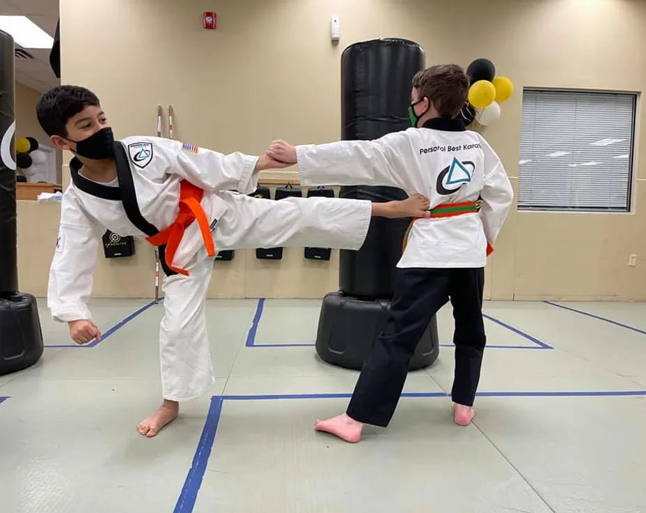 a couple of people in karate uniforms