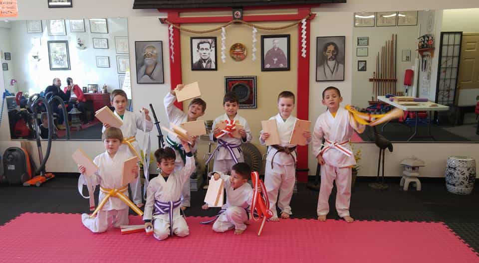 a group of children in karate uniforms