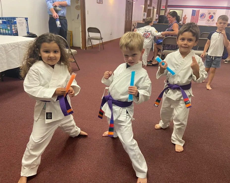 a group of children in karate uniforms