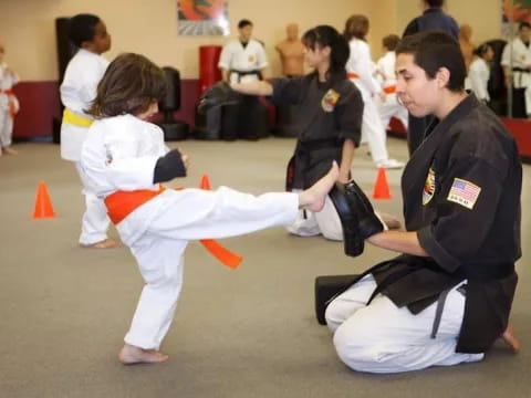 a man and a woman in karate uniforms