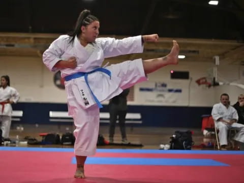 a couple of women in karate uniforms