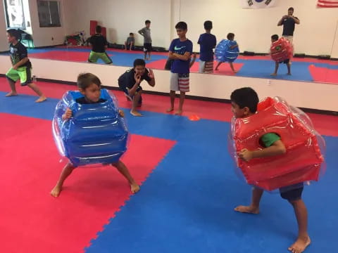 a group of kids playing on mats