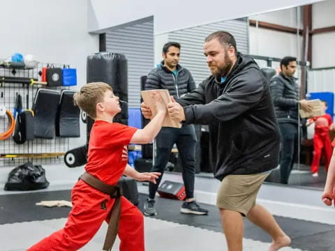 a man and a boy in a martial arts uniform