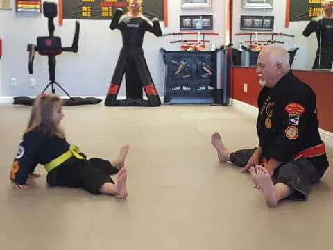 a person and a girl kneeling on the floor