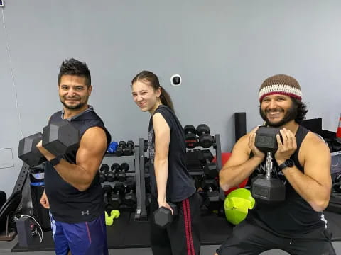 a group of people posing for a photo with exercise equipment