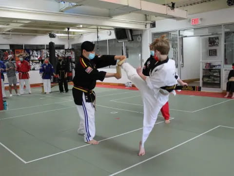 a couple of people in karate uniforms