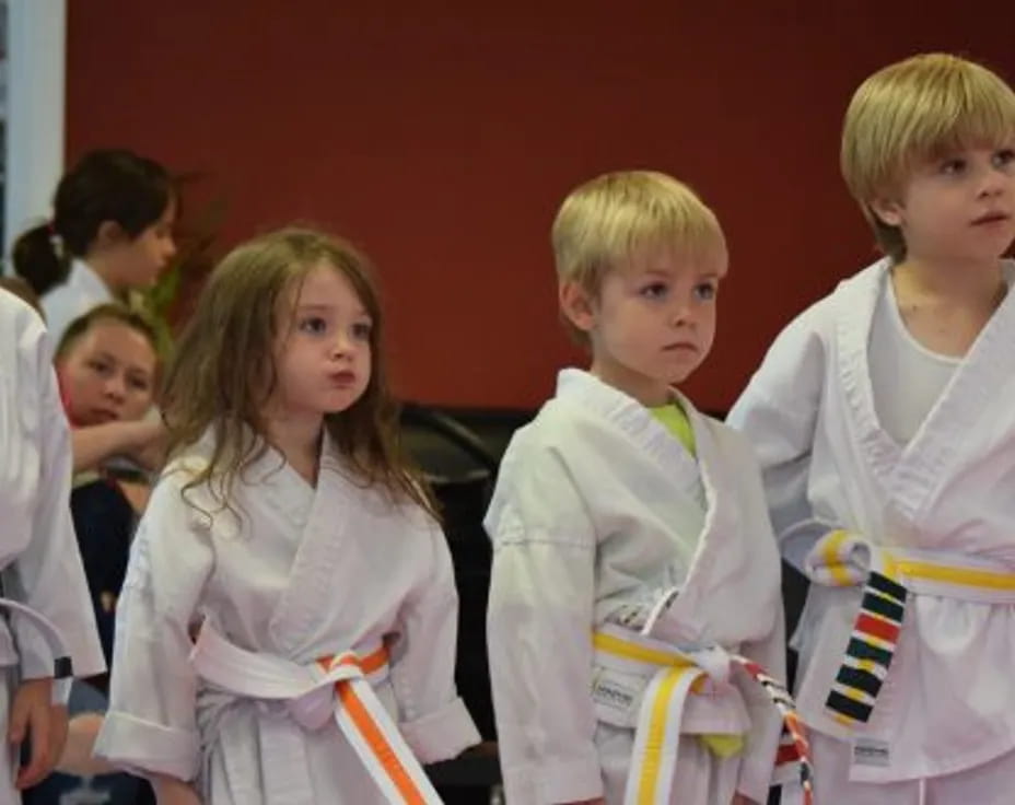 a group of children in white shirts