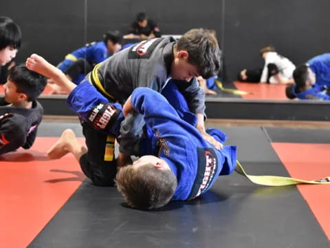 a person in a blue uniform doing a push up on another man