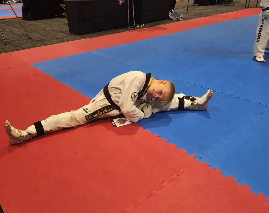 a person lying on a red mat