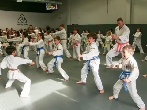 a group of children in karate uniforms