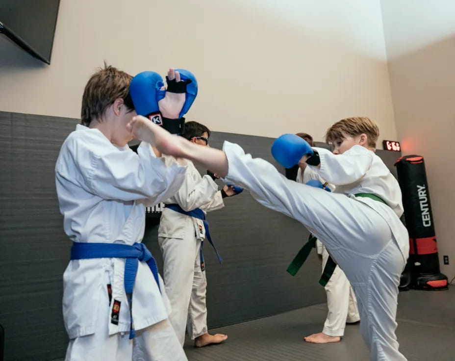 a group of people in white karate uniforms with blue balls
