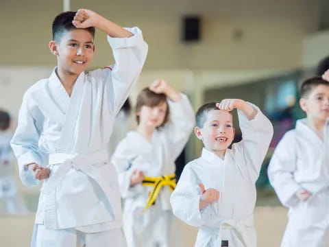 a group of children in karate uniforms