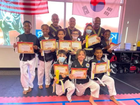 a group of people holding certificates