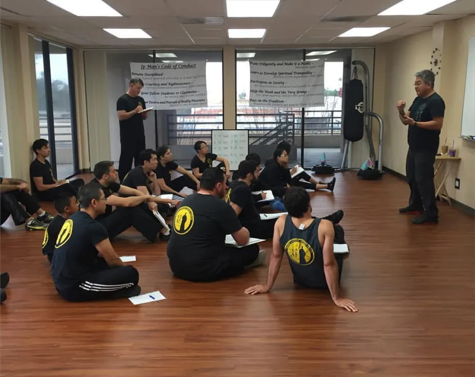 a group of people sitting on the floor in a room