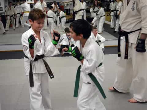 a group of people in white karate uniforms