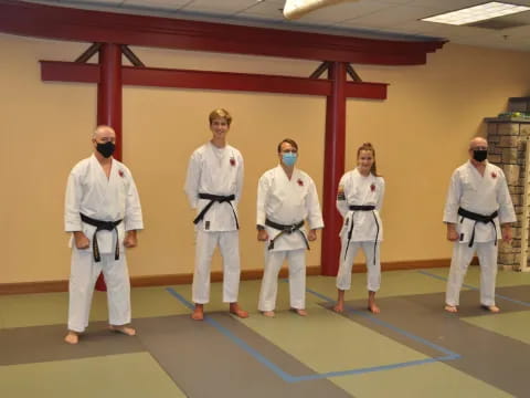 a group of people in white karate uniforms