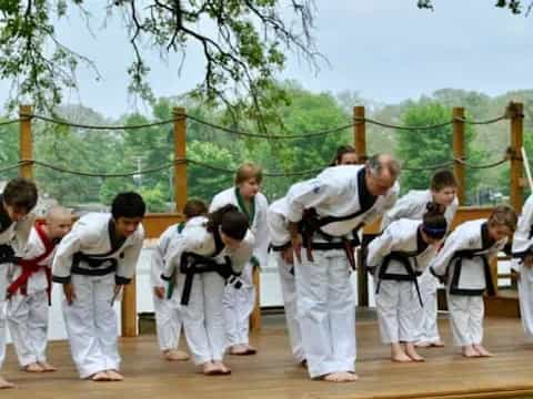 a group of people in white karate uniforms