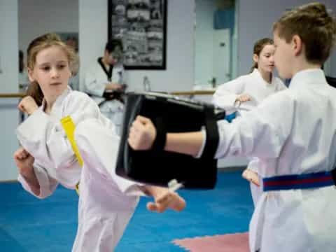 a group of people in karate uniforms