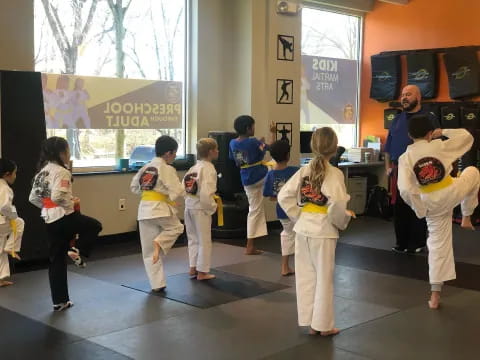 a group of children in karate uniforms