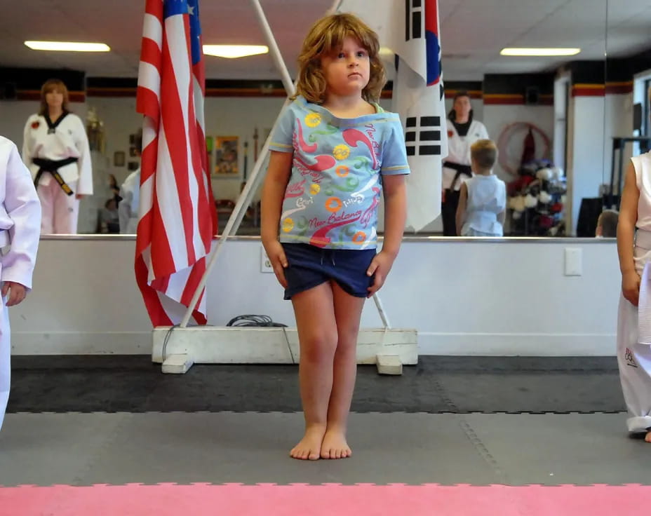 a group of children in karate uniforms