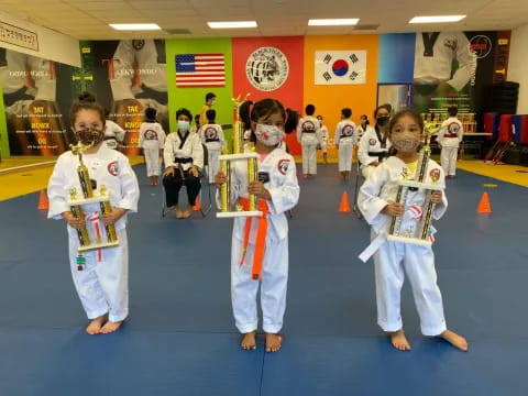 a group of kids in karate uniforms