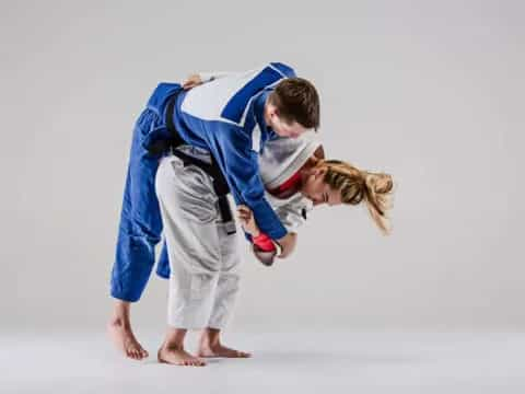 a man and a woman in karate uniforms