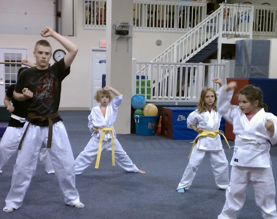 a group of children in karate uniforms